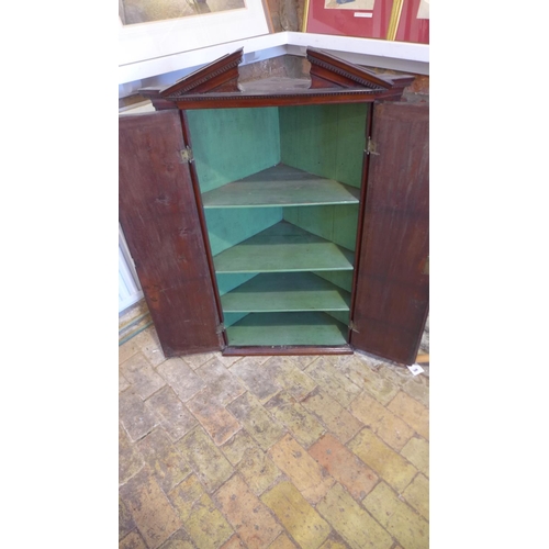 86 - A Georgian mahogany corner cupboard with two shell inlaid doors and a painted interior, 113cm tall x... 