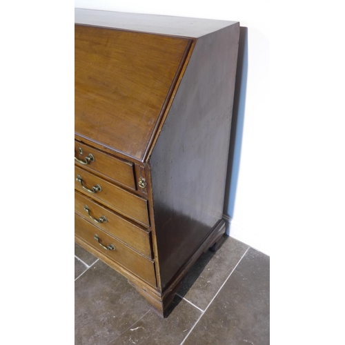 55 - A Georgian mahogany five drawer bureau on ogee bracket feet, 110cm tall x 116cm x 55cm, with a fitte... 