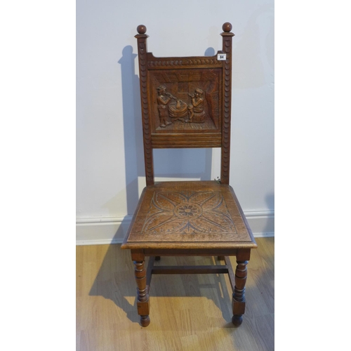 59 - A Victorian carved oak side chair with a carved back of musicians in a tavern, 108cm tall x 48cm wid... 