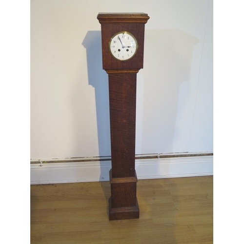 106 - An oak case 8 day granddaughter clock with French striking movement - Height 126cm - cracks to dial ... 