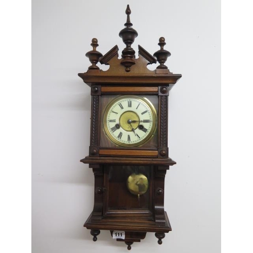 111 - A walnut spring driven striking wall clock - Height 60cm - running order