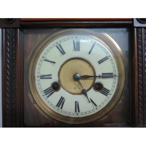 111 - A walnut spring driven striking wall clock - Height 60cm - running order