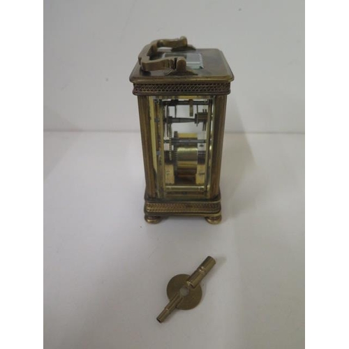 112 - A brass carriage clock with key - Height 13cm - one small chip to glass otherwise good