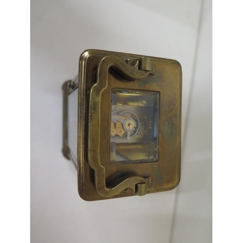 112 - A brass carriage clock with key - Height 13cm - one small chip to glass otherwise good