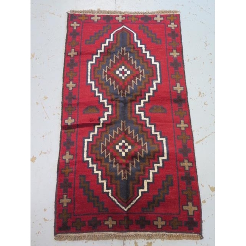132 - A hand knotted woollen Baluchi rug - 140cm x 77cm