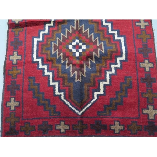 132 - A hand knotted woollen Baluchi rug - 140cm x 77cm