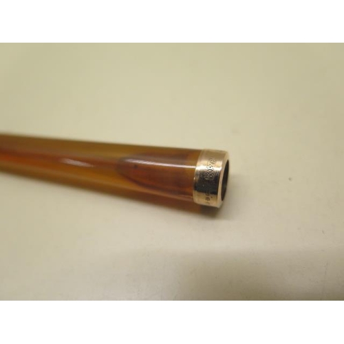 246 - A long ladies cigarette holder with a hallmarked 9ct yellow gold band - length 14cm - with original ... 
