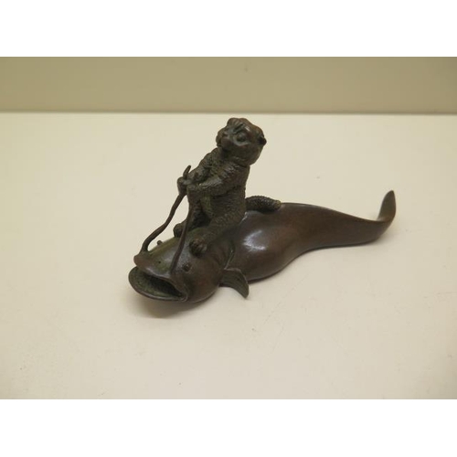 254 - A bronze cat on fish, signed to base - Length 12cm