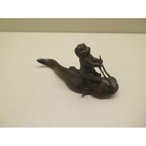 254 - A bronze cat on fish, signed to base - Length 12cm