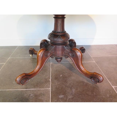 41 - A Victorian burr walnut oval tilt top breakfast table on four scroll supports - Height 73cm x 152cm ... 