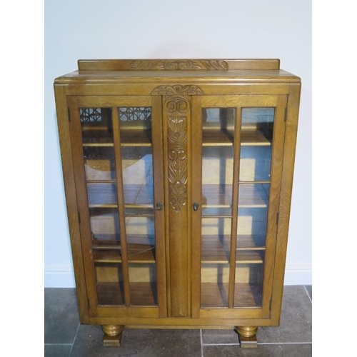 44 - An oak two door glazed Scully display cabinet - Height 126cm x 91cm x 29cm