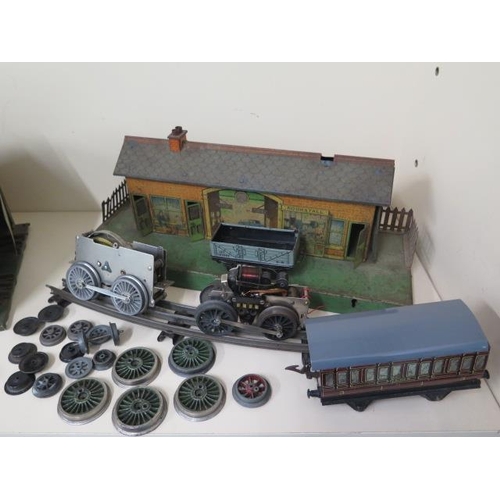 703 - A Hornby O Gauge three rail tinplate double loco shed - length 50cm x 25cm x 23cm - missing two chim... 