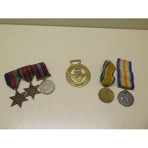 727 - Two WWI medals to T-4449 Pte SW Holloway The Queens R, three unnamed WWII medals and a Churchill bra... 