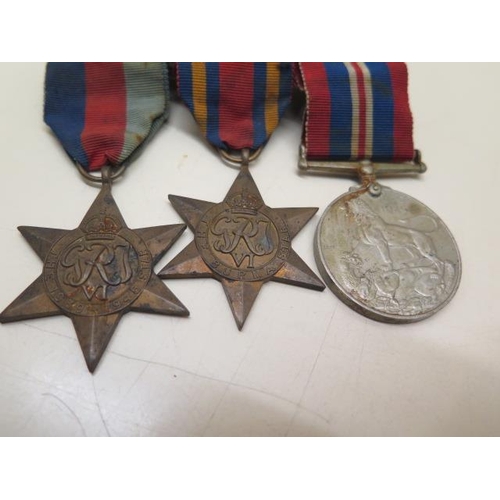 727 - Two WWI medals to T-4449 Pte SW Holloway The Queens R, three unnamed WWII medals and a Churchill bra... 