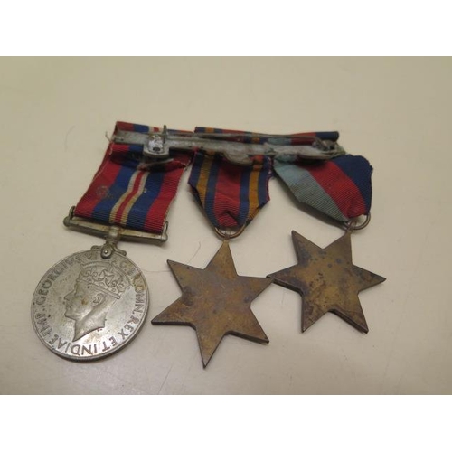 727 - Two WWI medals to T-4449 Pte SW Holloway The Queens R, three unnamed WWII medals and a Churchill bra... 