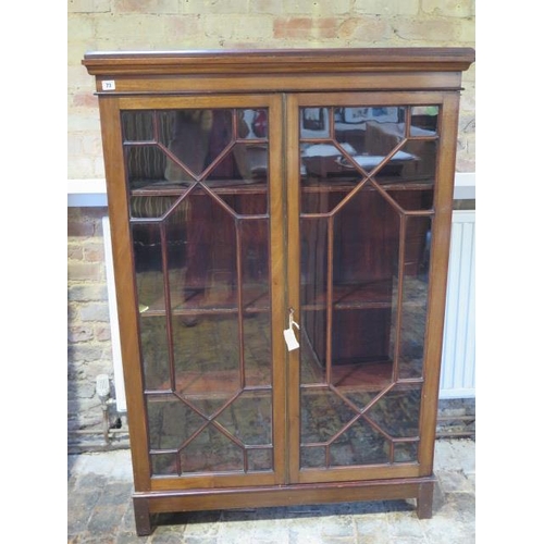 73 - A mahogany astragal glazed two door bookcase with a three adjustable shelves and key - Height 149cm ... 