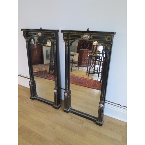 75 - A pair of Empire 19th century ebonised pier mirrors with porcelain plaques and ormolu mounts - 104cm... 