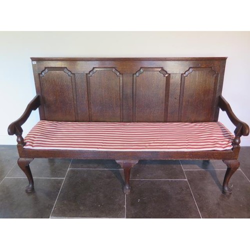 40 - A Georgian oak hall settee bench with panelled back and scroll arms on cabriole shaped front legs - ... 