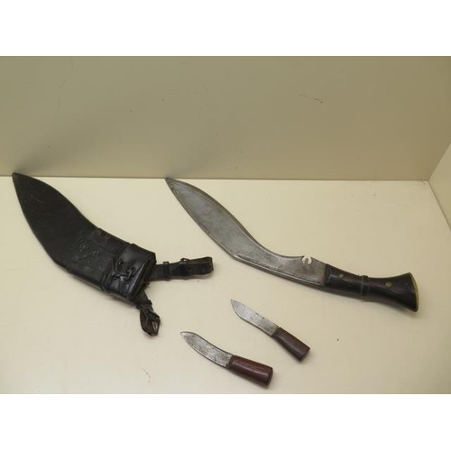 1025 - A horn handle Kukri with 31cm blade in leather covered wood scabbard together with its accompanying ... 