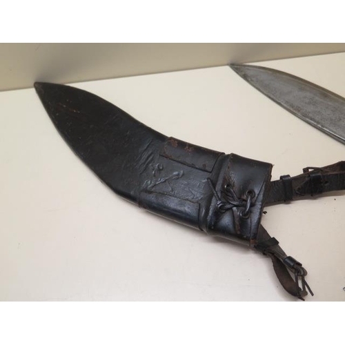 1025 - A horn handle Kukri with 31cm blade in leather covered wood scabbard together with its accompanying ... 