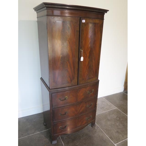 52 - A Georgian style mahogany bowfronted cupboard on three drawer chest - height 162cm x 70cm x 43cm