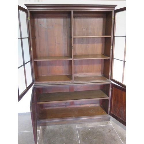 56 - A good Georgian mahogany bookcase on cupboard of small proportions with a two door glazed top over a... 