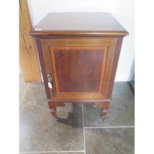 57 - An Edwardian mahogany bedside cupboard on casters - height 76cm x 49cm x 47cm