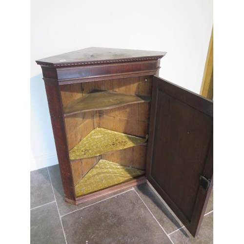 64 - A Georgian oak corner cupboard with shell inlay - height 107cm x width 81cm