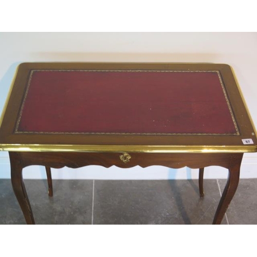 67 - A Continental side table with a leather inset top and a side drawer - height 72cm x 81cm x 49cm