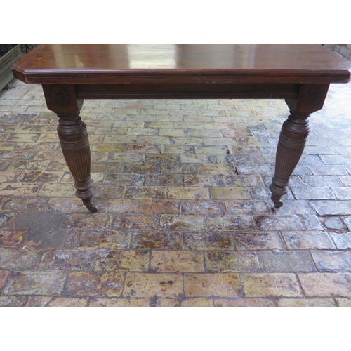 70 - A late Victorian walnut two leaf wind out dining table on reeded legs - height 74cm x width 122cm, e... 