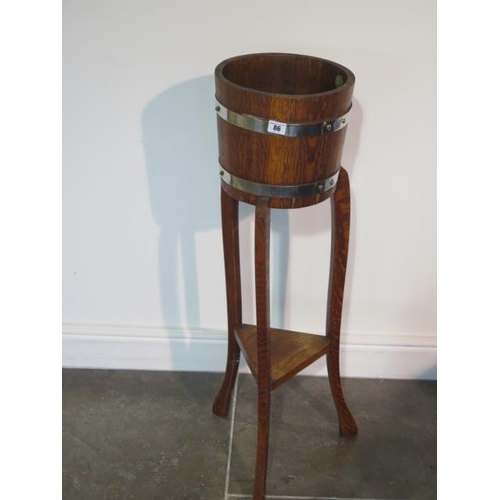 86 - An oak barrell type plantstand by R Alister & Co - height 92cm x diameter 27cm - rickerty, needs att... 