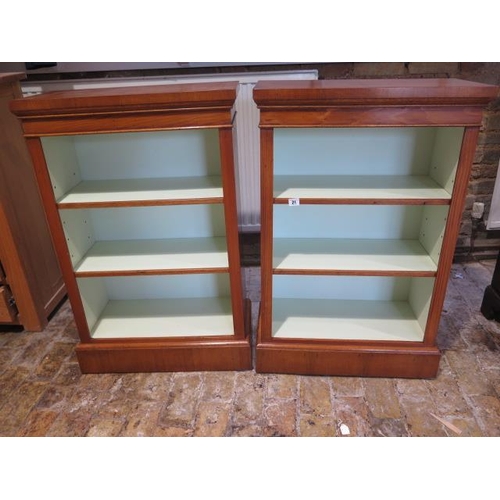 26 - A pair of walnut open bookcases with painted interior and adjustable shelves made by a local craftsm... 