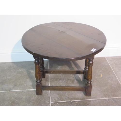 22 - A small oak drop leaf joint stool type table - height 46.5cm, top closed width 26cm , open 60cm