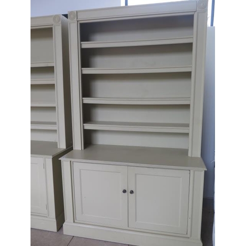 13 - A pair of handmade country house painted bookcase cabinets, each with an adjustable shelved top abov... 