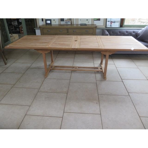 44 - A new teak garden table extends from 184cm to 297cm with two folding leaves - Width 110cm