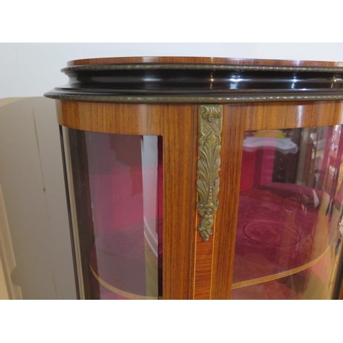 58 - A pair of 20th century marquetry inlaid vitrine display cabinets with bow glass panels and ormolu mo... 