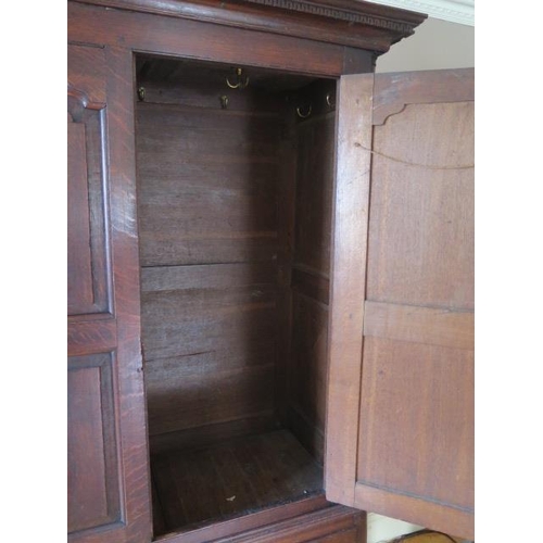 72 - An 18th century oak  cupboard on chest with two panelled doors above four drawers on shaped bracket ... 