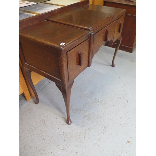 82 - An oak Art Deco style three drawer side table on shaped legs, 82cm tall x 107cm x 47cm