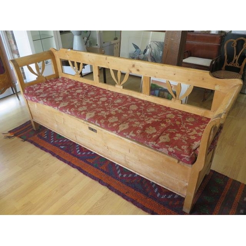 83 - A 19th century continental stripped pine hall bench with lift upseat and cushion, 90cm tall x 210cm ... 