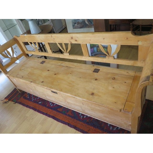 83 - A 19th century continental stripped pine hall bench with lift upseat and cushion, 90cm tall x 210cm ... 