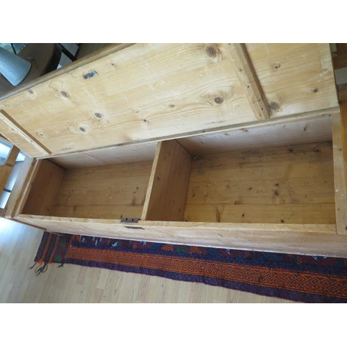 83 - A 19th century continental stripped pine hall bench with lift upseat and cushion, 90cm tall x 210cm ... 