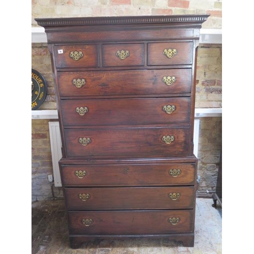 86 - A Georgian oak chest on chest with an arrangement of three small drawers above six long drawers on b... 