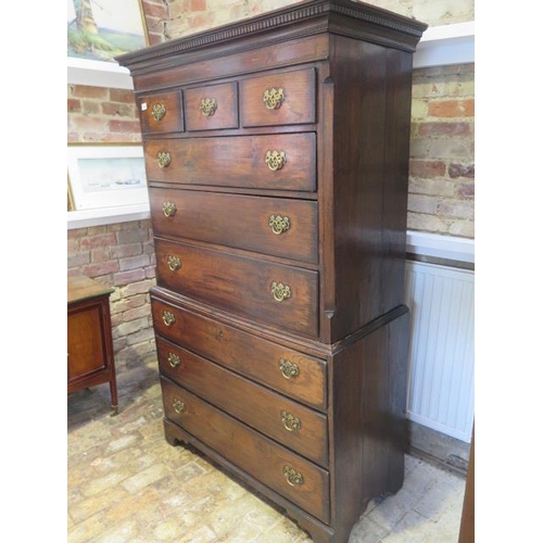 86 - A Georgian oak chest on chest with an arrangement of three small drawers above six long drawers on b... 