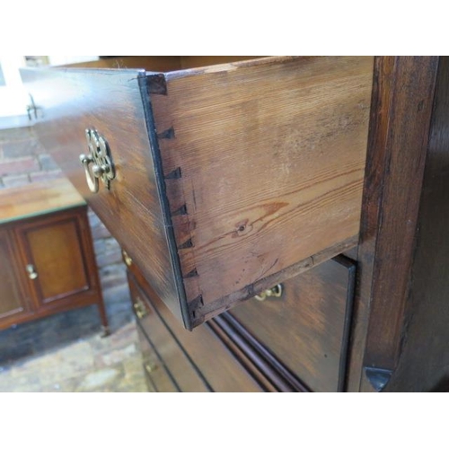 86 - A Georgian oak chest on chest with an arrangement of three small drawers above six long drawers on b... 