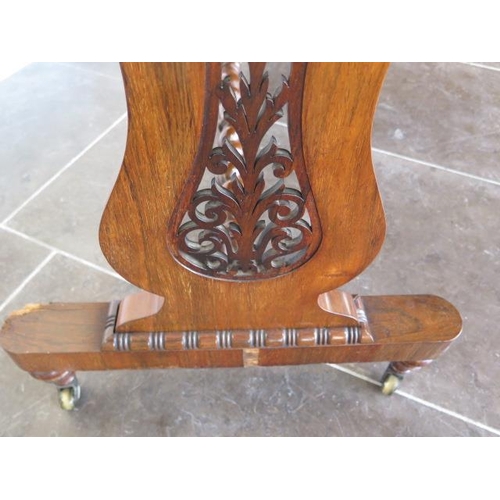 82 - A 19th century rosewood and burr walnut stretcher table on lyre end supports united by a barley twis... 