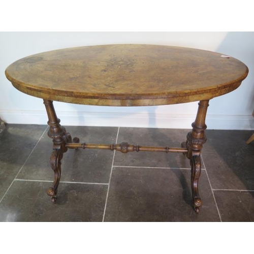 90 - A Victorian inlaid burr walnut oval centre table on carved supports united by a turned stretcher, 71... 