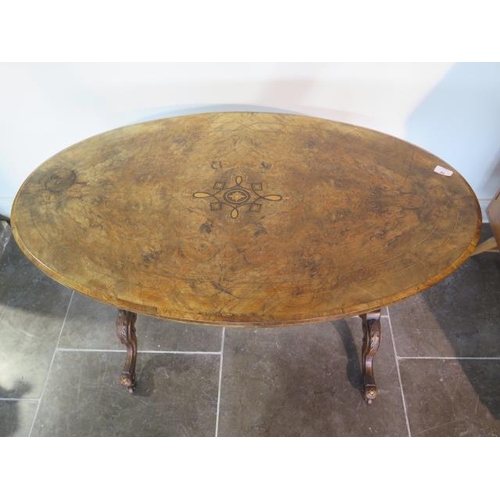 90 - A Victorian inlaid burr walnut oval centre table on carved supports united by a turned stretcher, 71... 