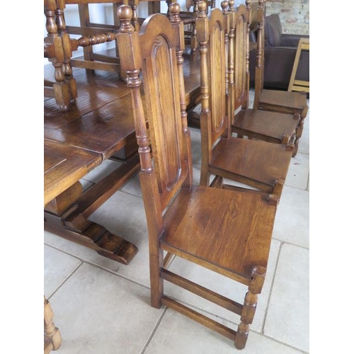 34 - A good quality antique style oak draw leaf refectory style table with 12 high back oak chairs having... 