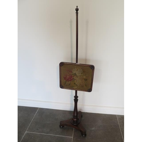 72 - An early Victorian rosewood pole screen with embroided banner in good condition, 142cm tall