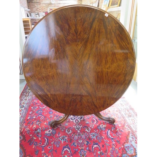 77 - A Victorian walnut tilt top breakfast / dining table on carved tripod base, 72cm tall x 133cm diamet... 